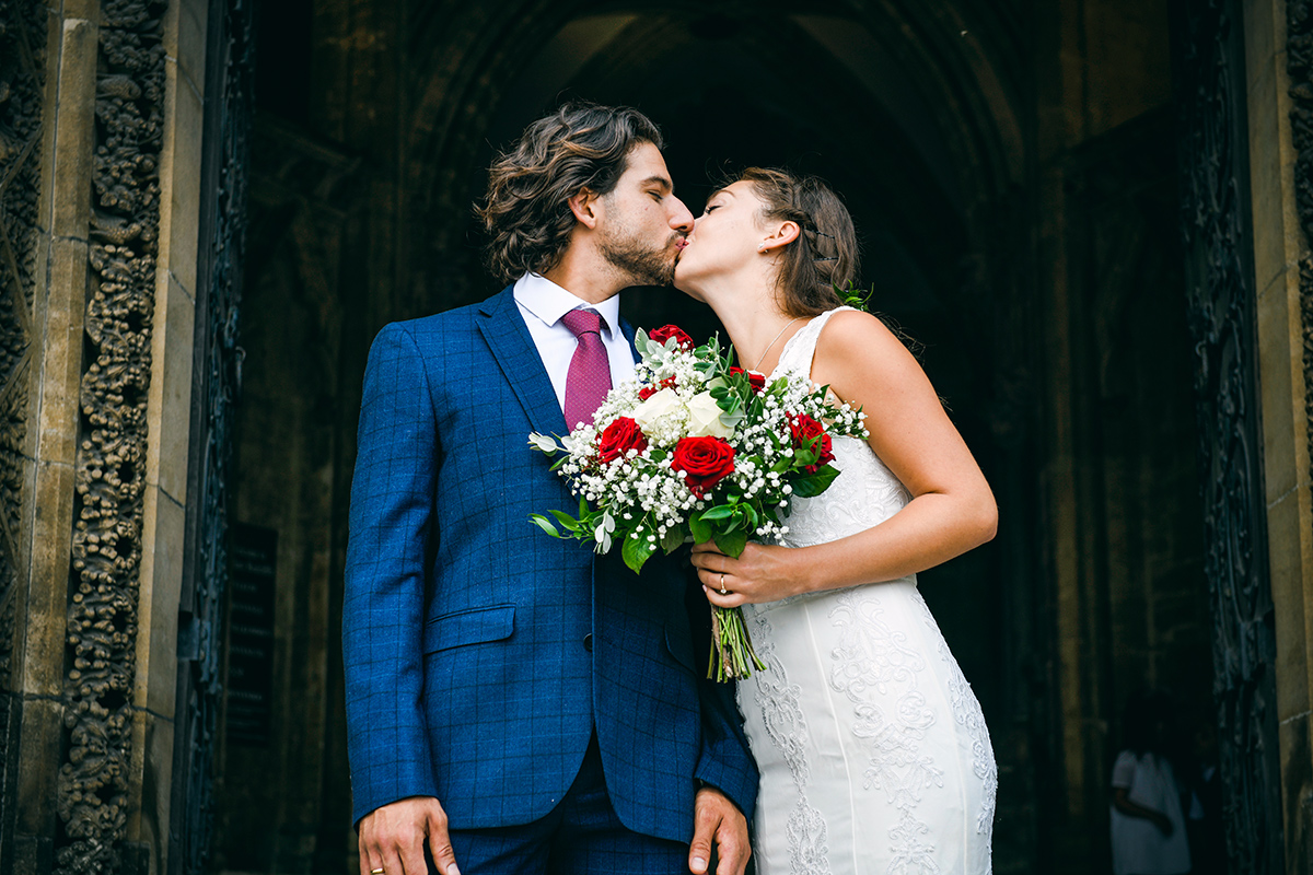 Wedding couple photographed on church steps in Spain